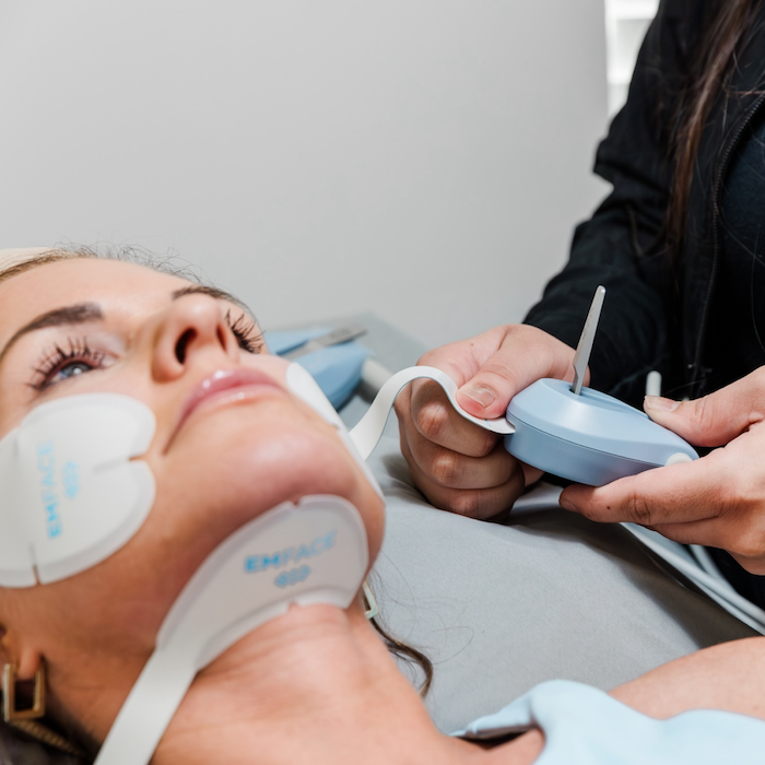 A Brightside Aesthetics provider is helping a patient prepare for Emface facial contouring in Des Moines.